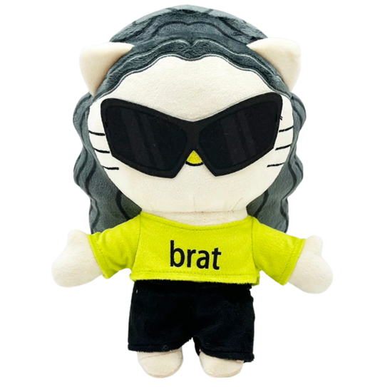 Plush toy resembling a cat with sunglasses and a 'brat' shirt on a white background
